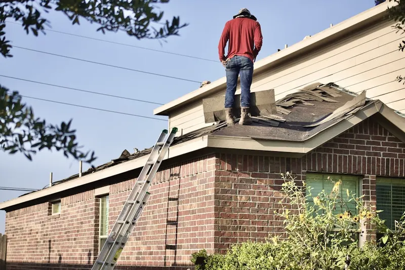 Professional roofer working on a residential roof in Laramie